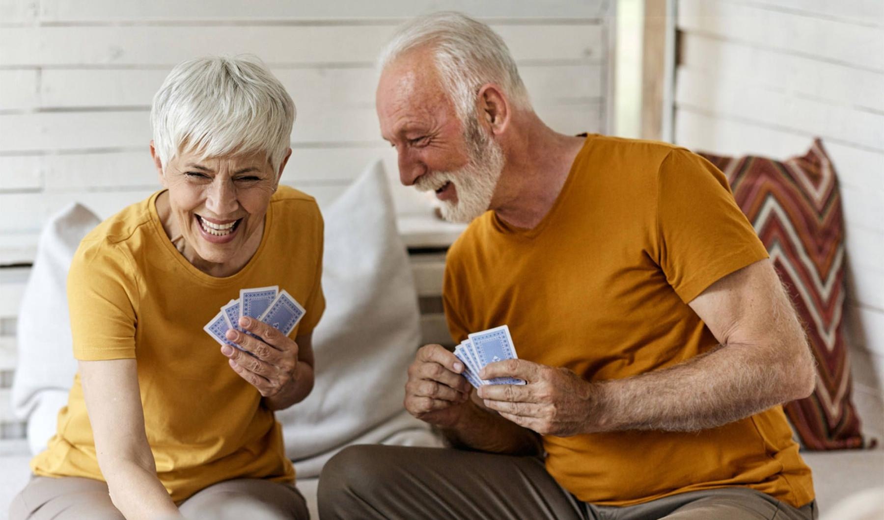 Find your perfect fit at William Booth Towers a man and woman sitting at a table playing cards