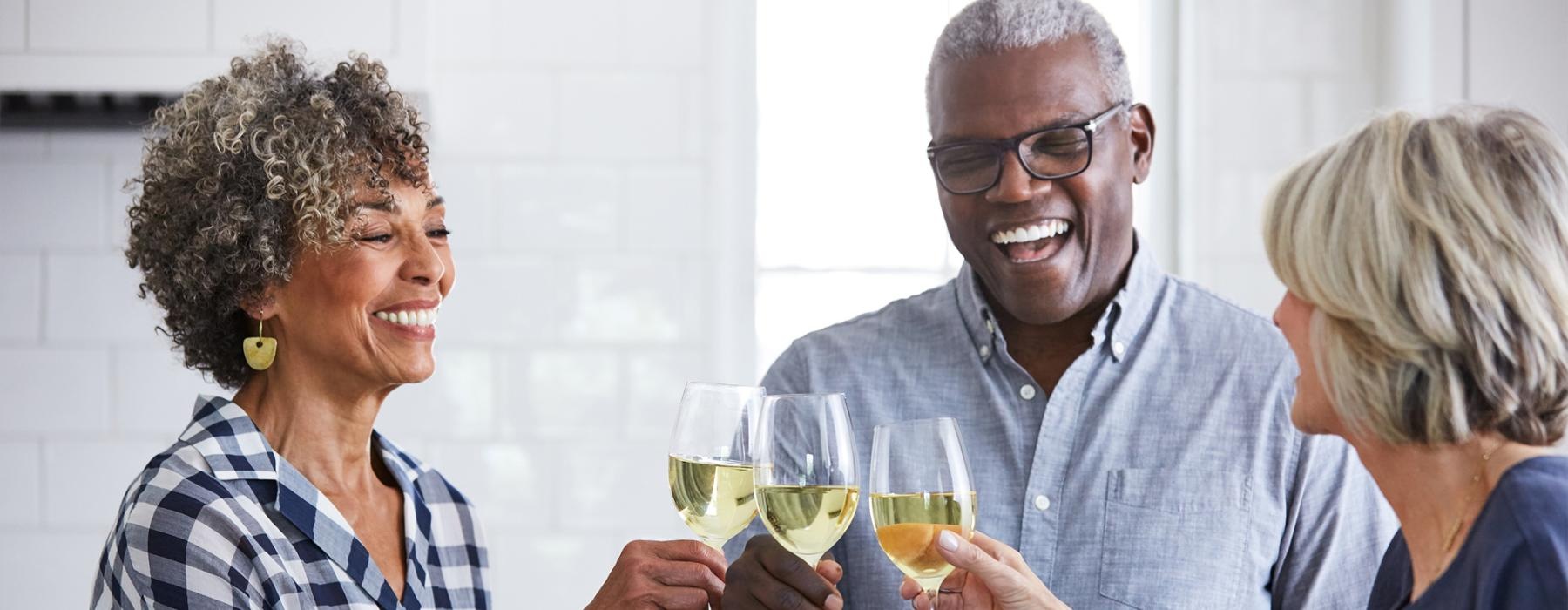 a few people toasting wine glasses