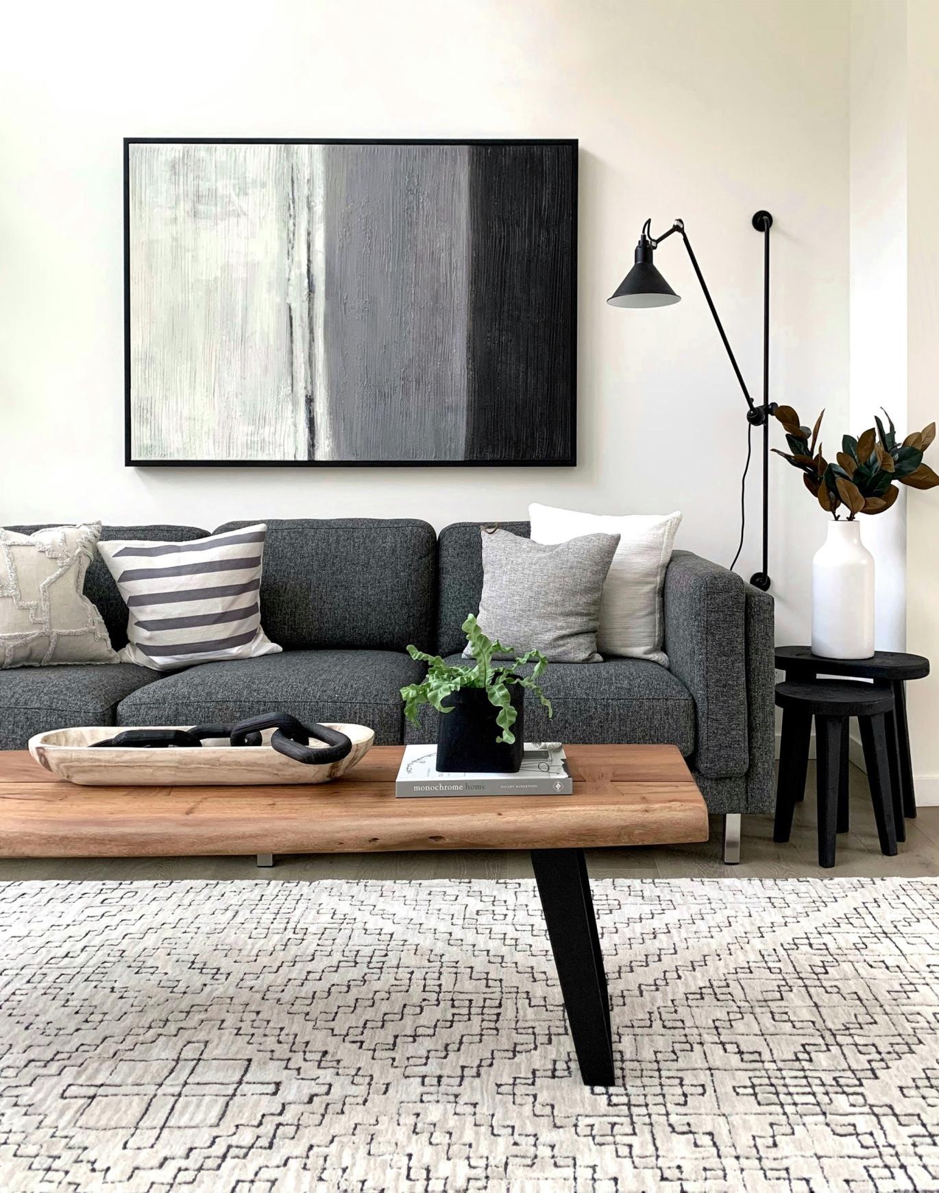 Settle into comfort at William Booth Towers a couch with a coffee table with a plant and decor on it